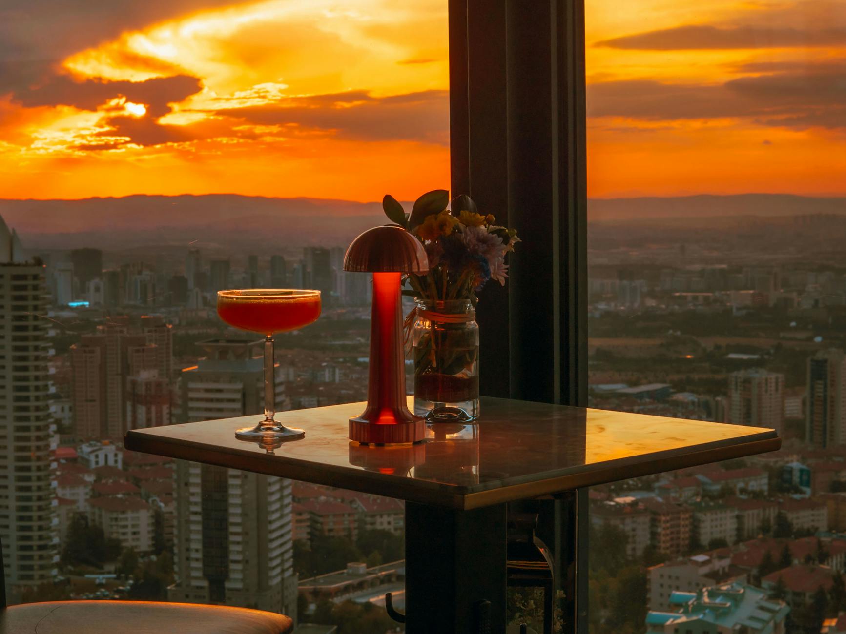 Stunning sunset view from a rooftop bar overlooking a city