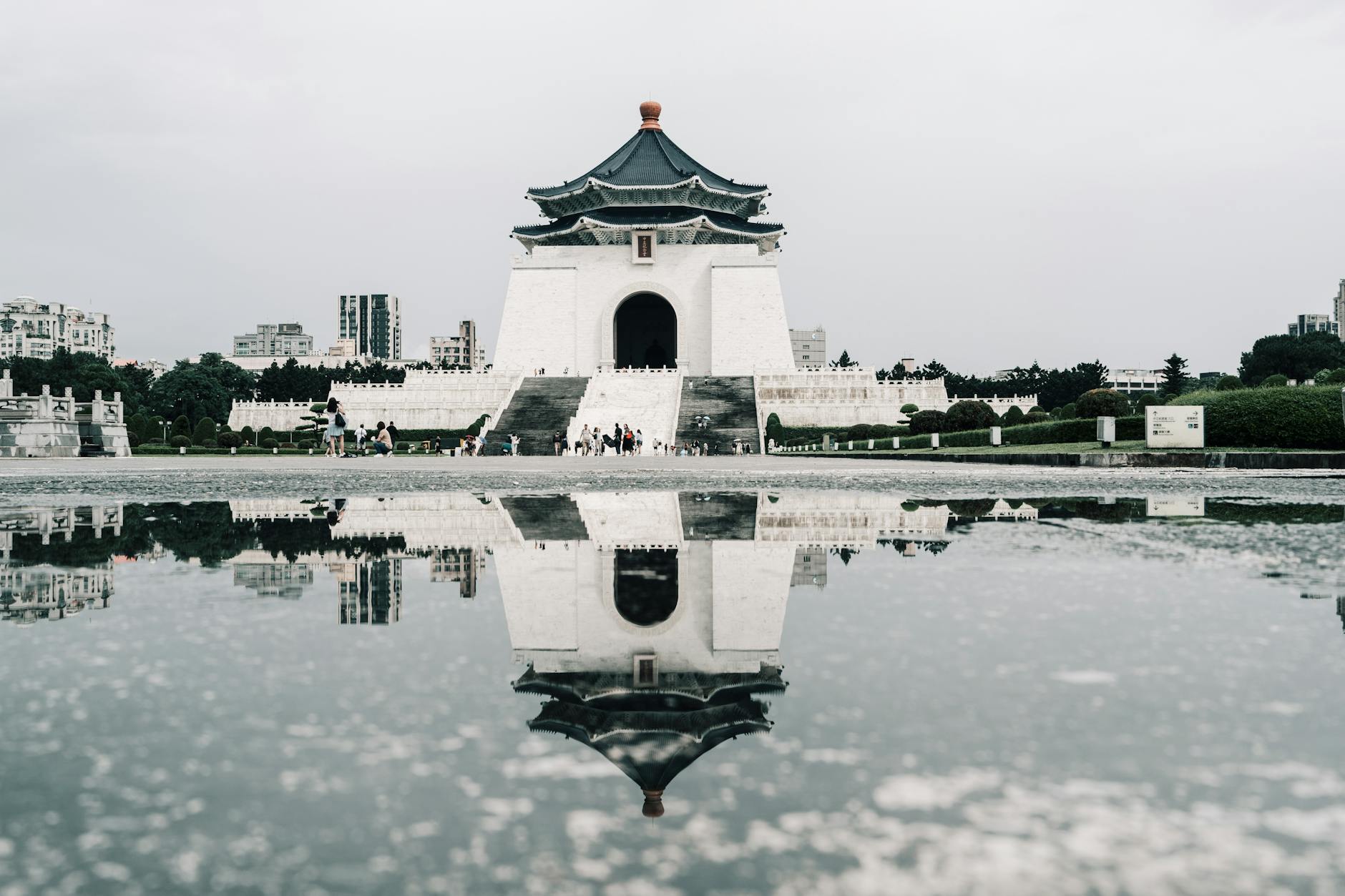Stunning reflection of Chiang Kai-shek Memorial Hall in a puddle in Taipei
