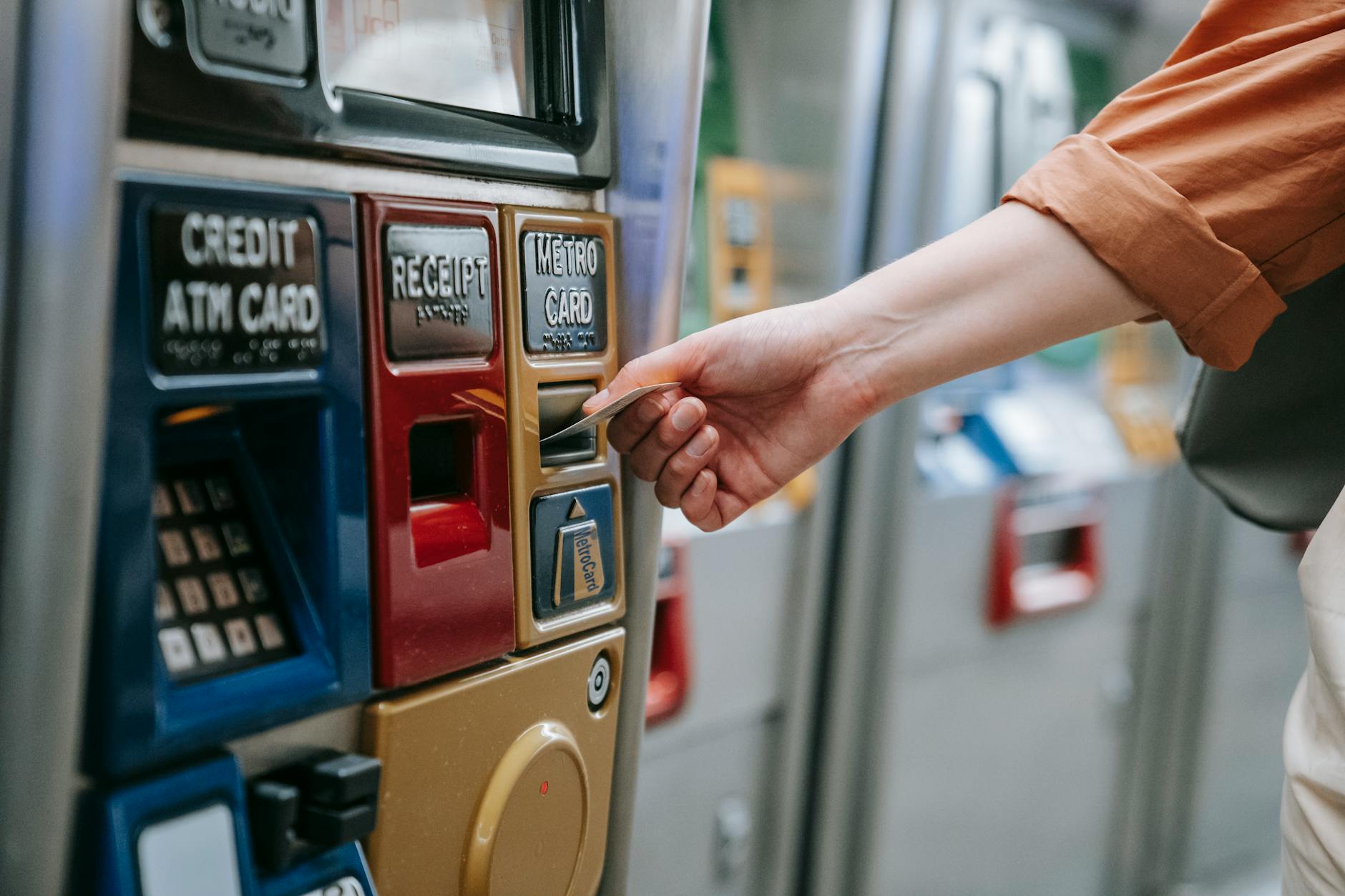 Person using a contactless transit card at a metro turnstile
