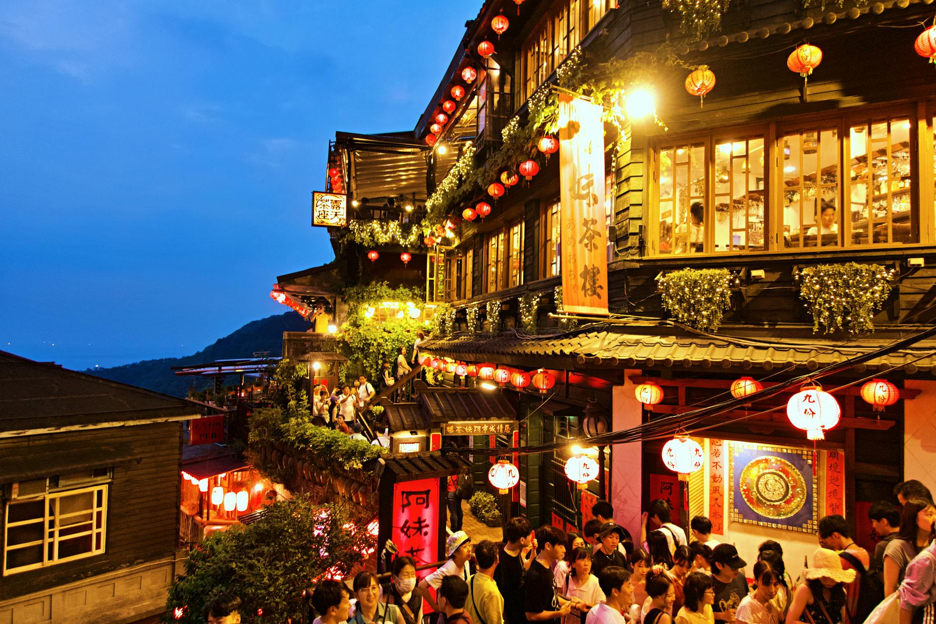 Red lanterns illuminating the narrow stone alleys of Jiufen Old Street at dusk