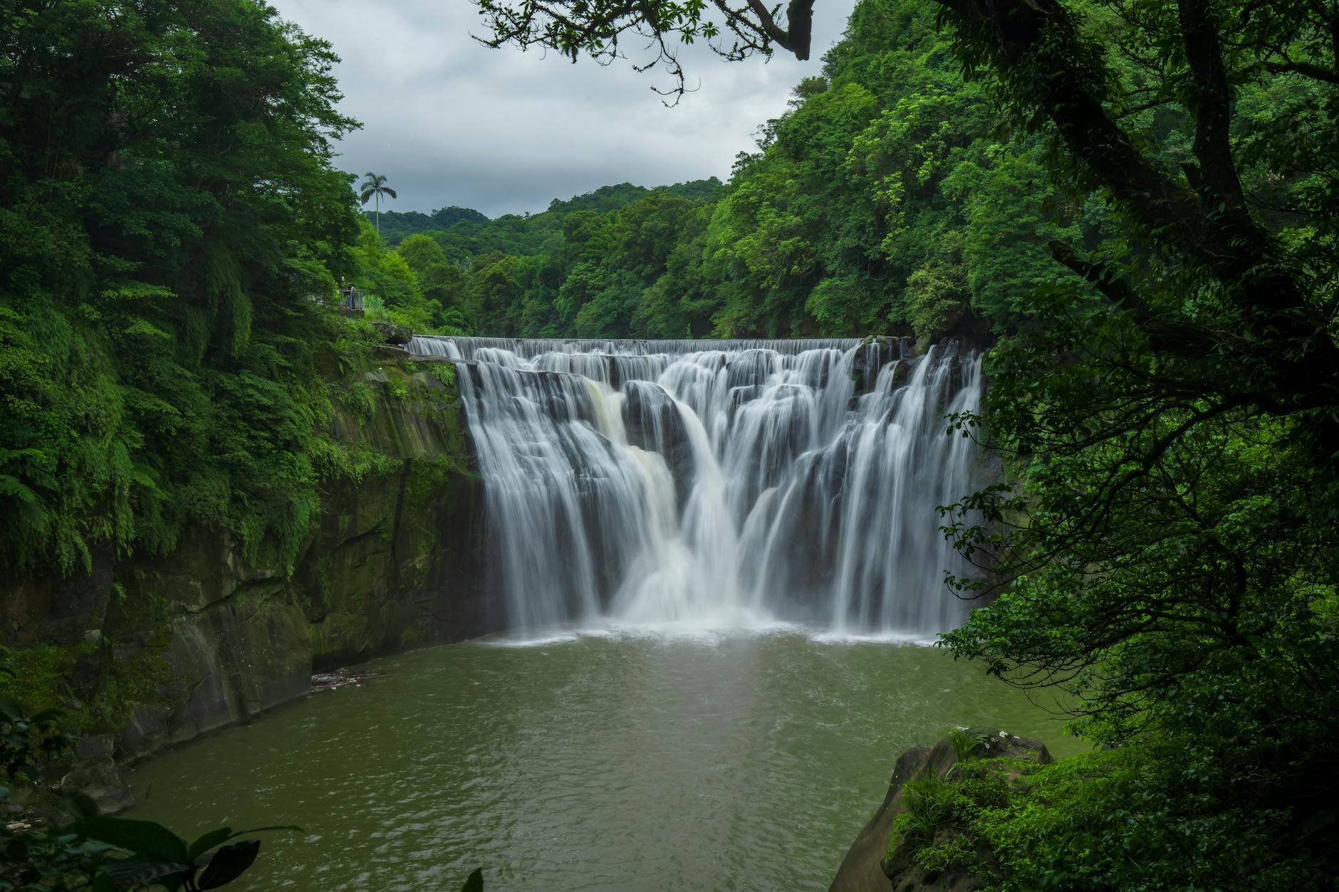 Breathtaking view of Shifen Waterfall surrounded by lush greenery