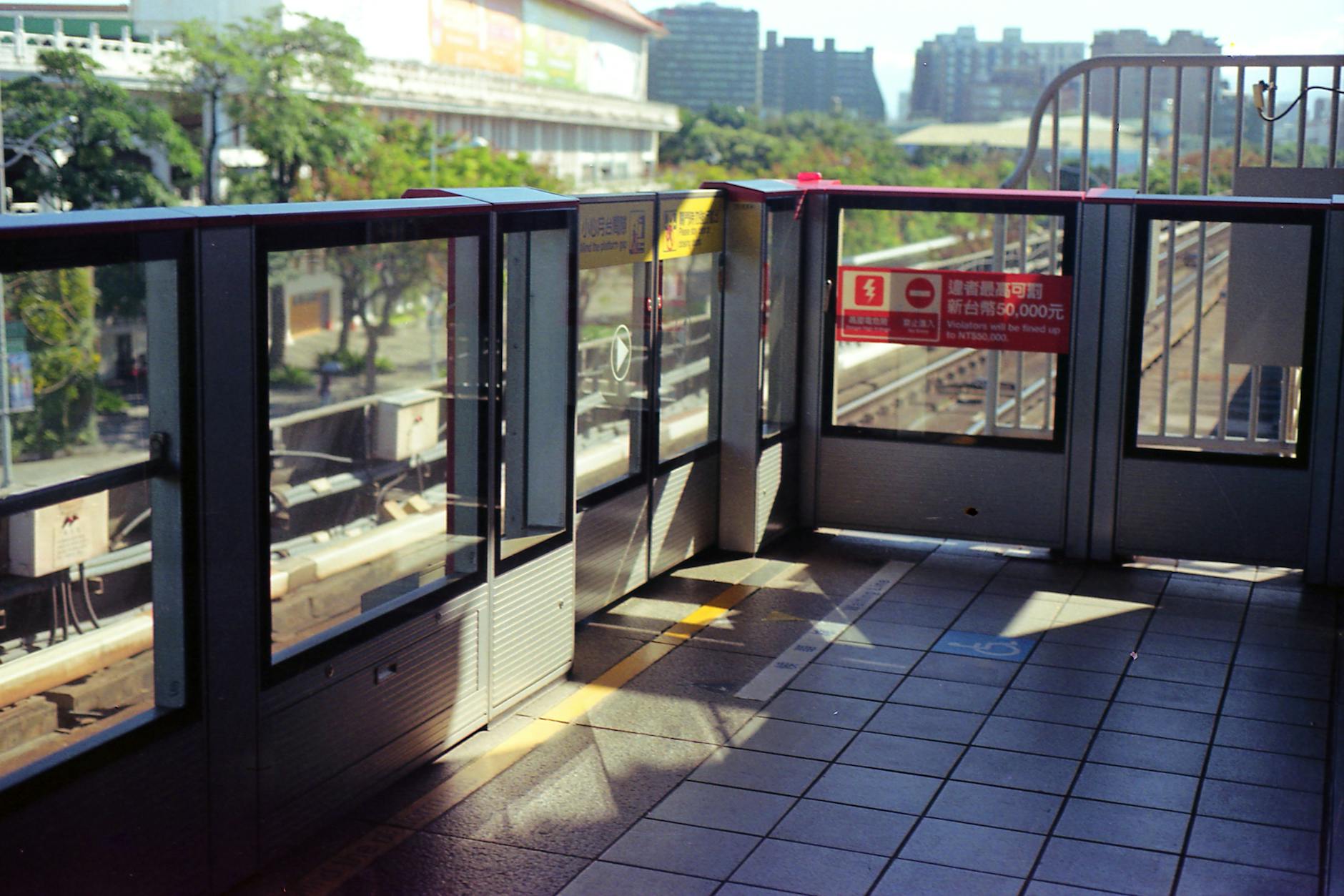 Bright Taipei Metro station platform with safety gates and modern design