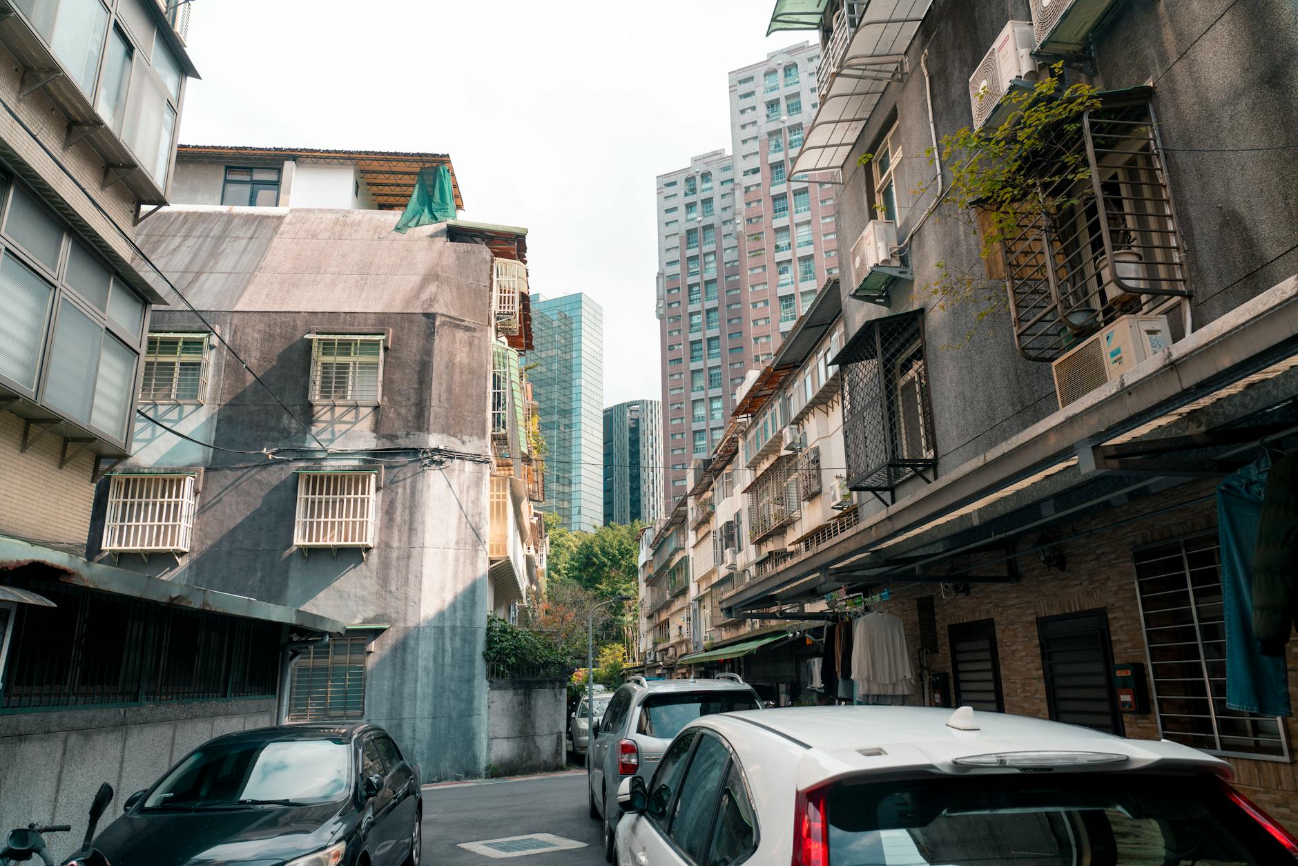 Bustling Taipei street with old and modern buildings showing the city's mix of districts