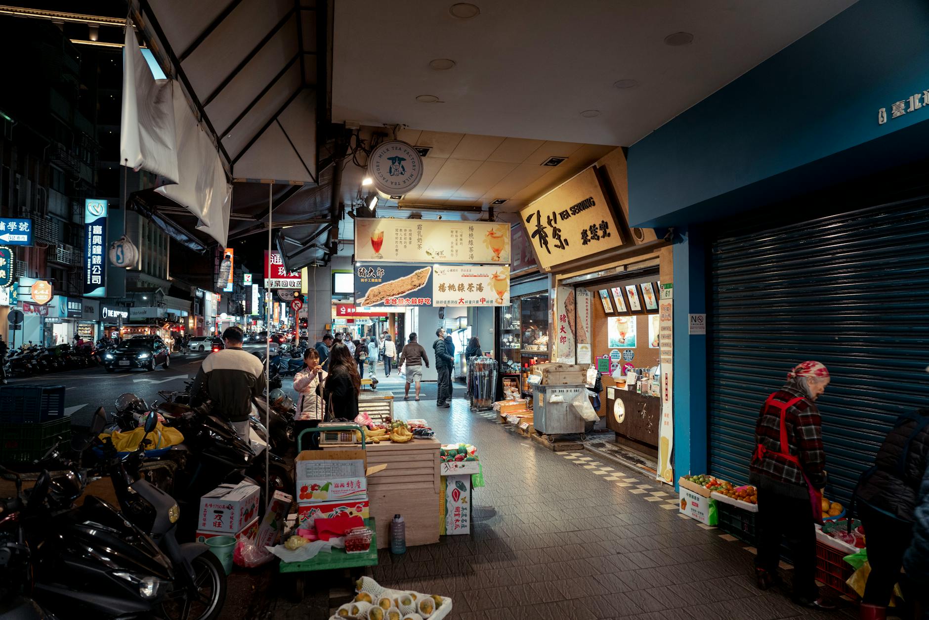 Bustling Taipei night market scene with lanterns, food stalls and shoppers