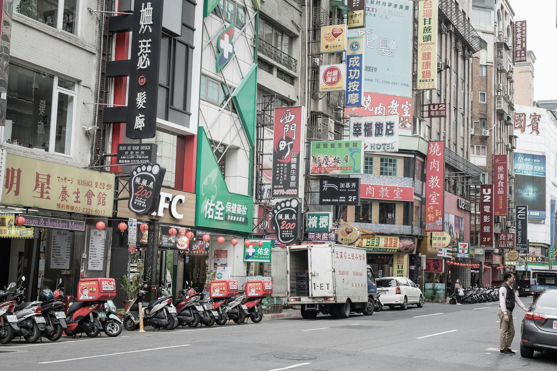Ximending pedestrian street in Taipei with neon signs and shops