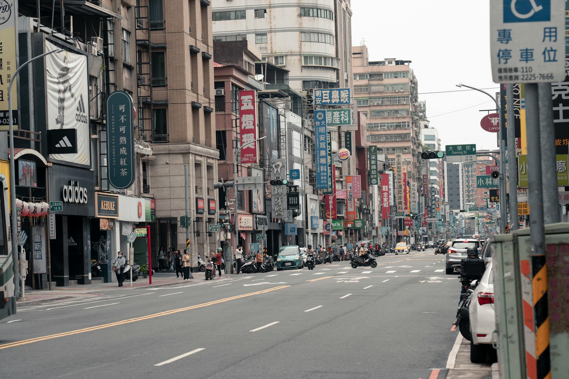 Lively street view in Taipei City showing local shops, traffic, and signage