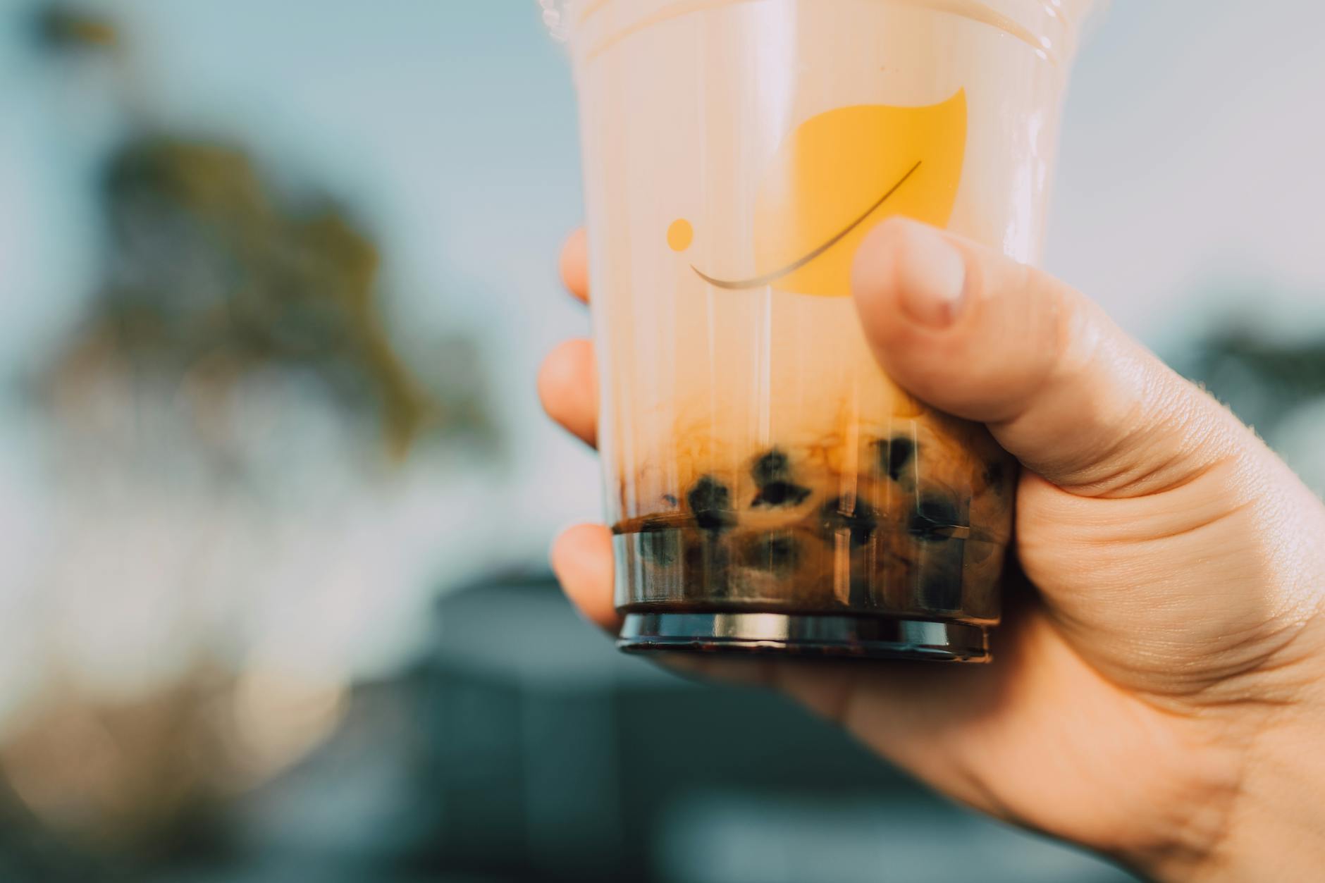 Vibrant image of a hand holding a bubble tea cup