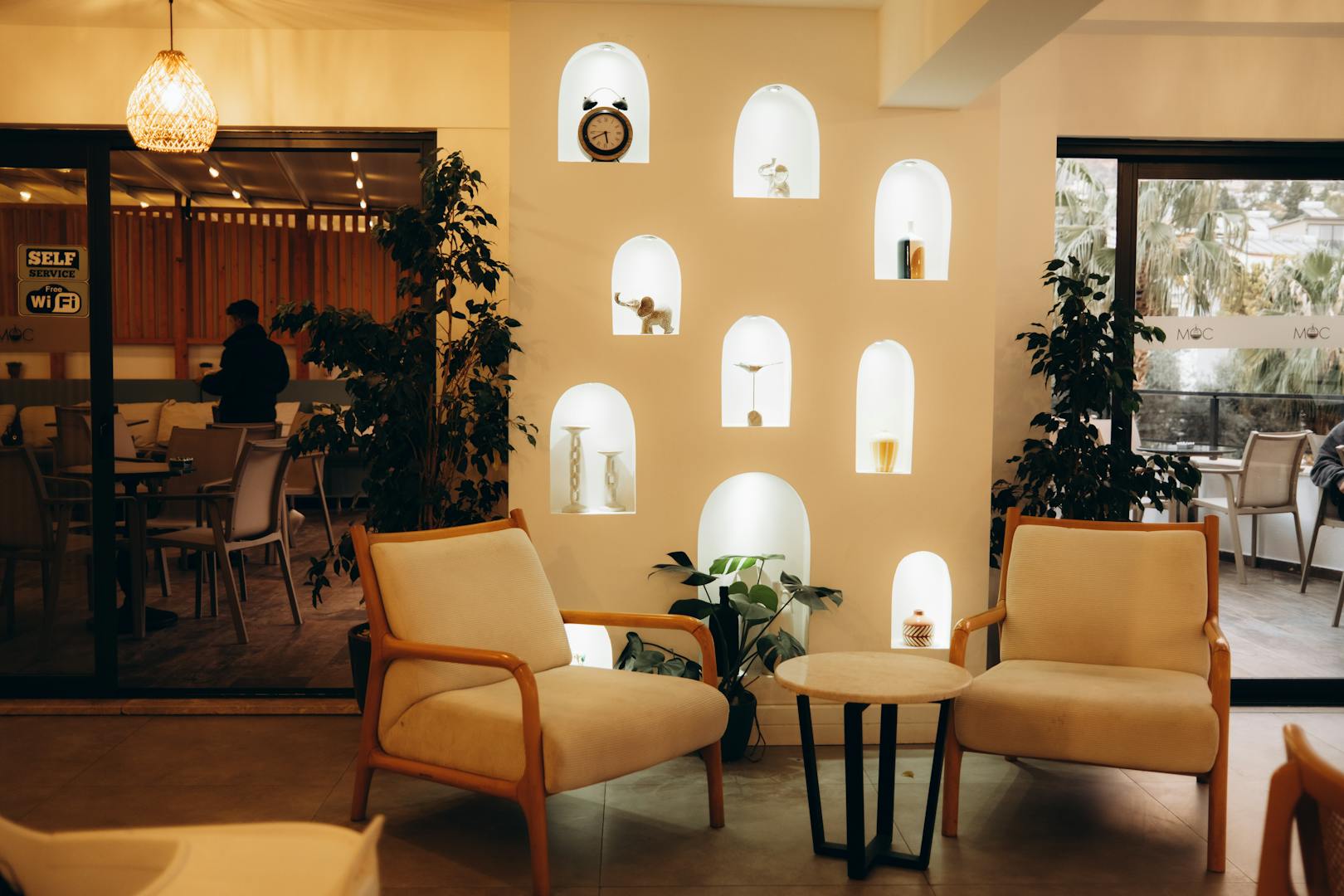 Cozy Taipei cafe interior with plants and book-lined walls