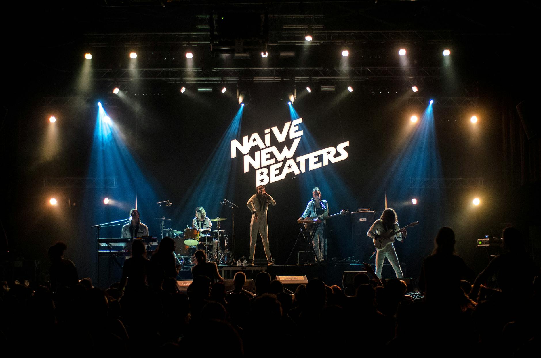 Vibrant live performance by a band on stage with dramatic lighting