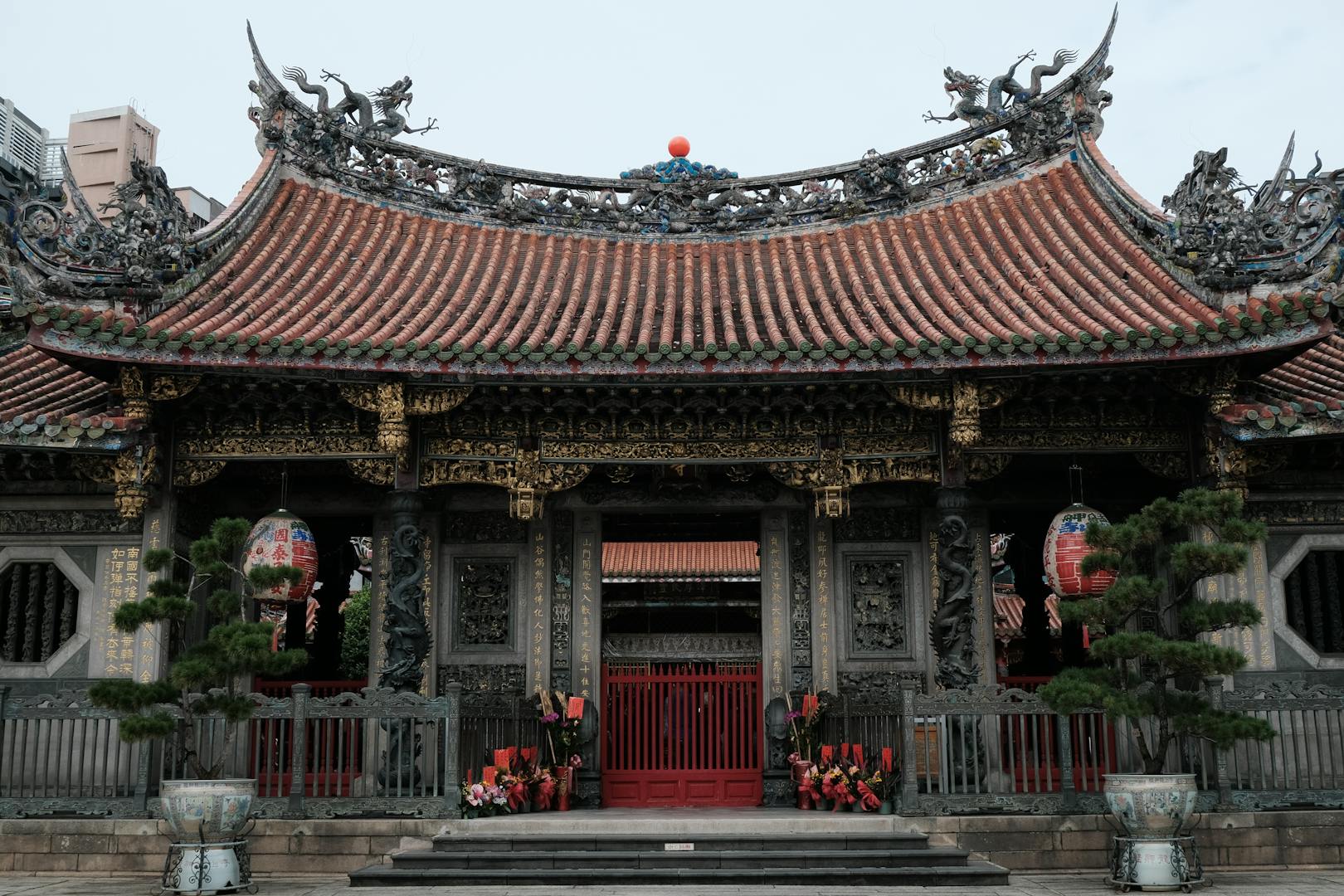 Longshan Temple architecture and incense at dusk near Huaxi Street Wanhua Taipei