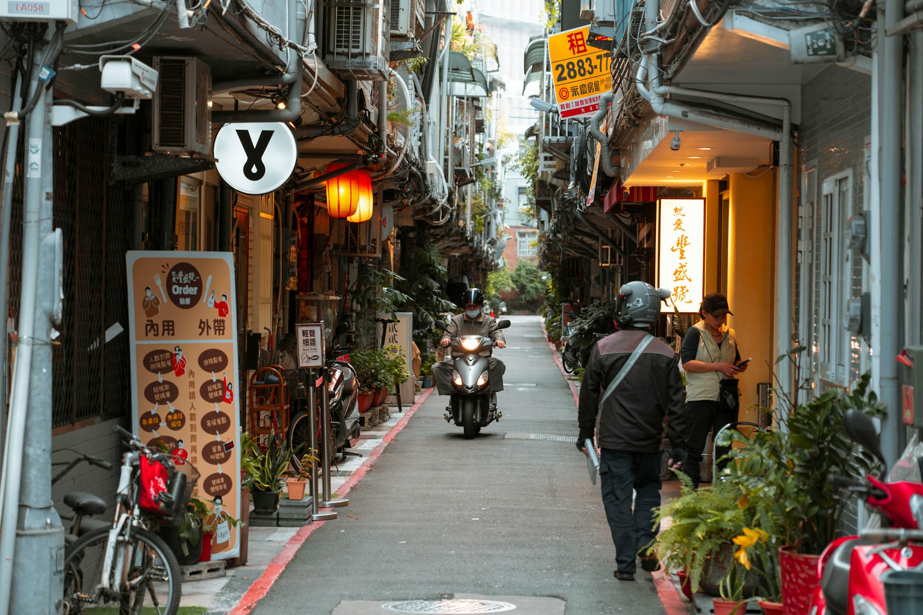Bustling Asian alley with scooters eateries and vibrant city life
