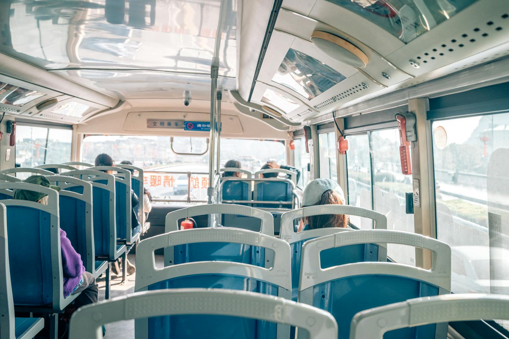 Interior of a Taipei city bus with passengers and signage