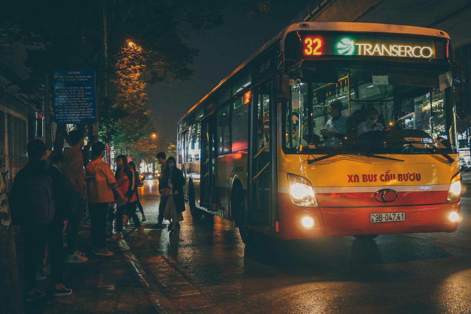 Taipei bus stop with route signs and waiting passengers