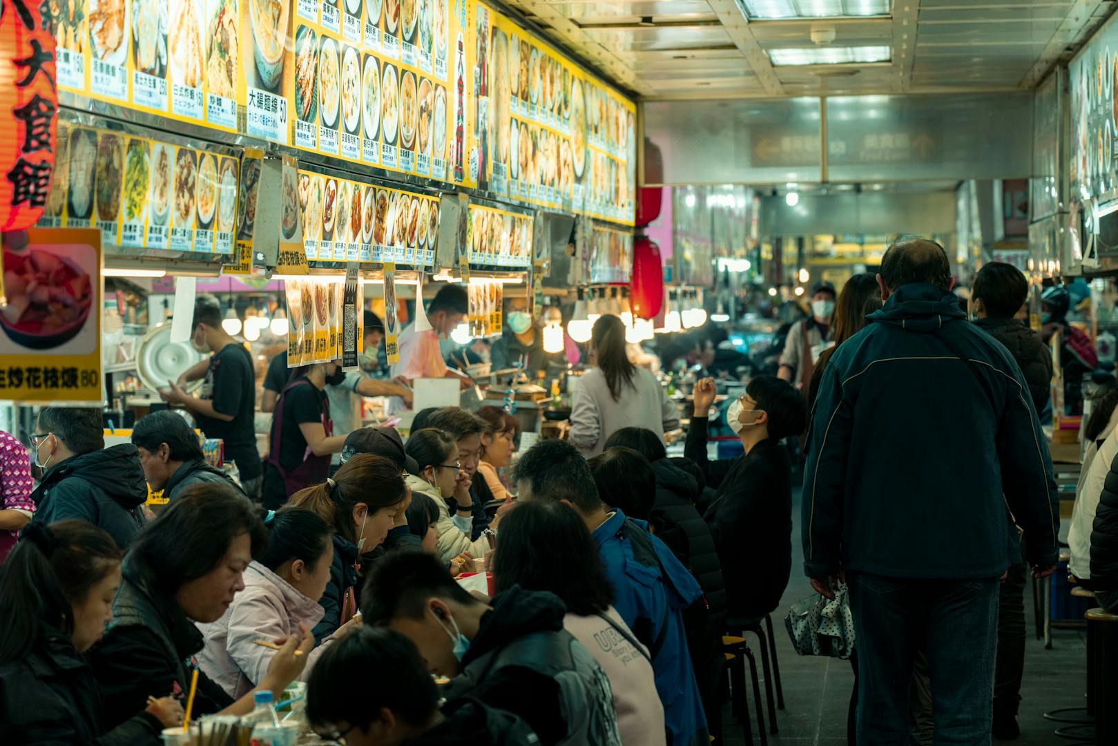 Tourist tasting Taiwanese street food on a Taipei food tour
