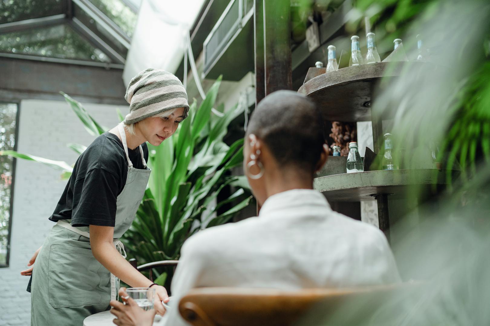 Waiter serving customers at a Taipei restaurant with no tipping culture