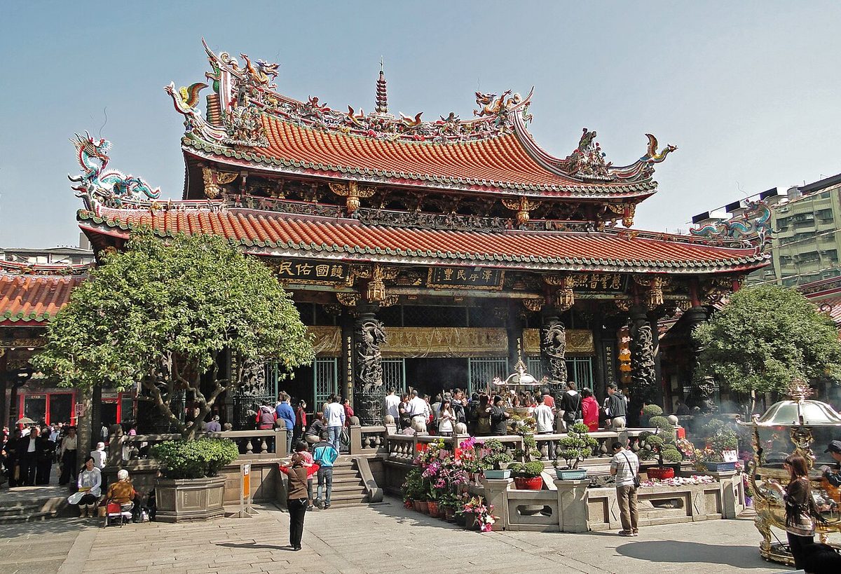 Worshippers burning incense at Longshan Temple in Taipei during Ghost Month in August