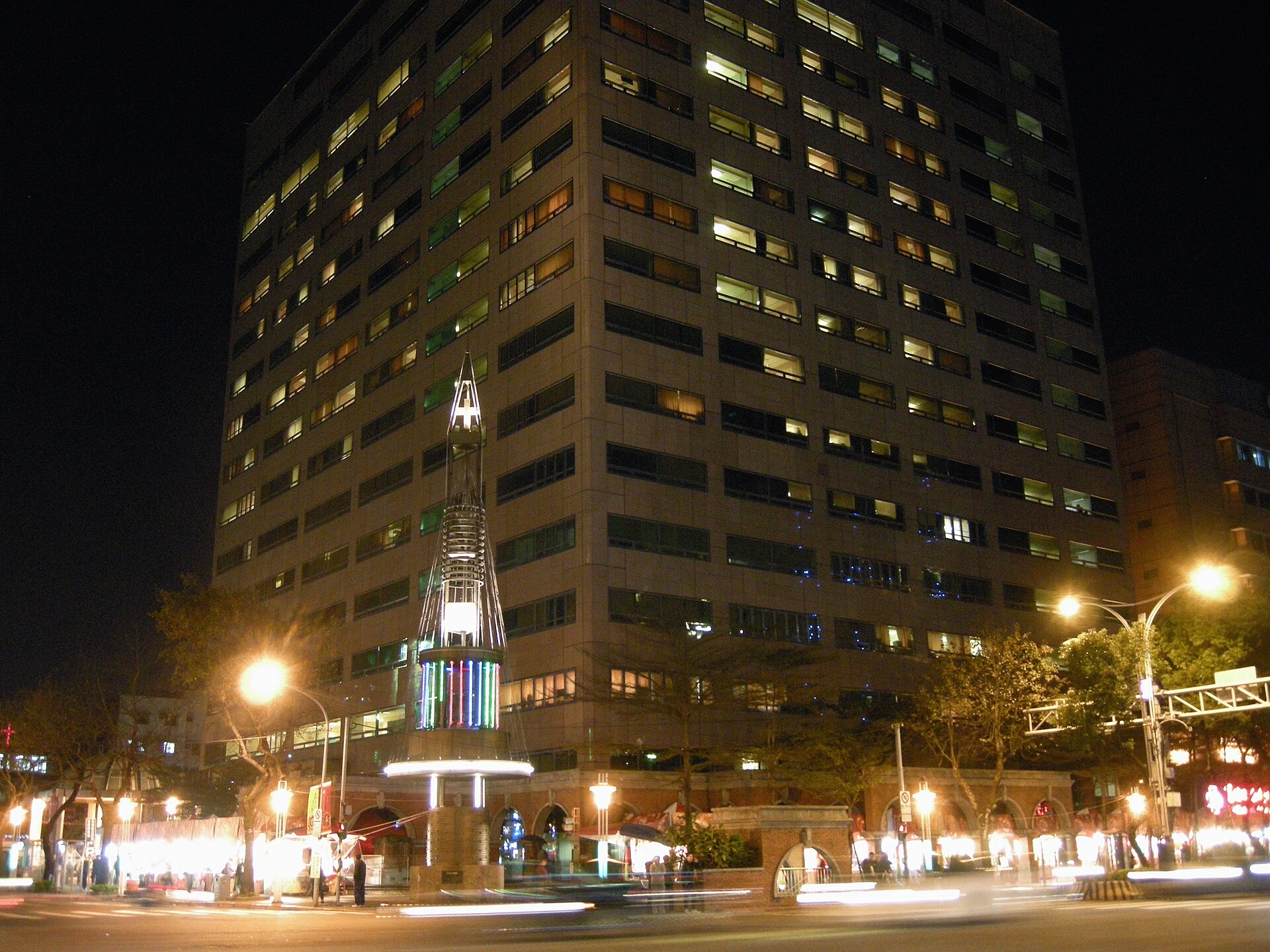 A large Taipei hospital building lit up at night