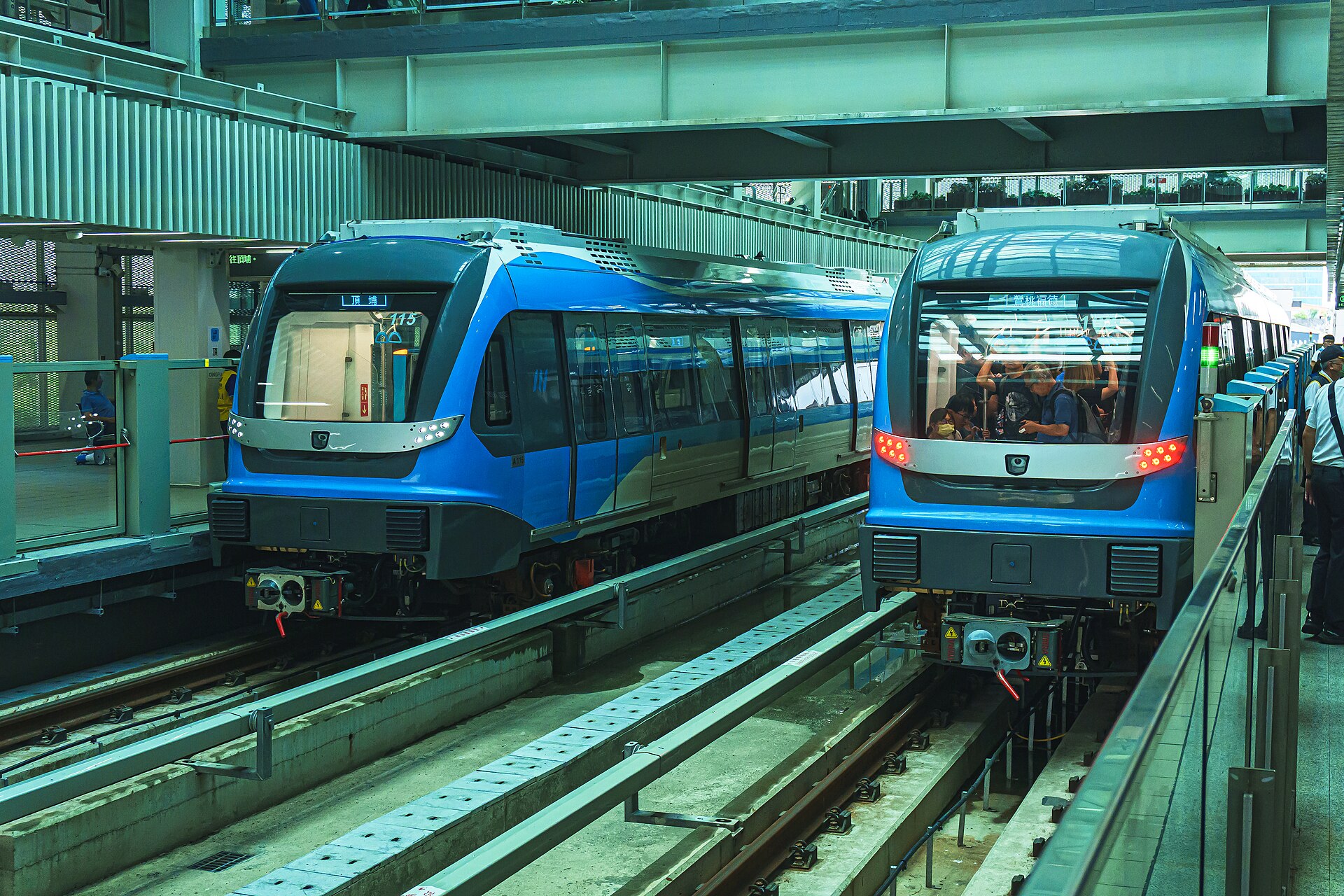 Two blue driverless Sanying Line metro trains at the platforms of Dingpu station