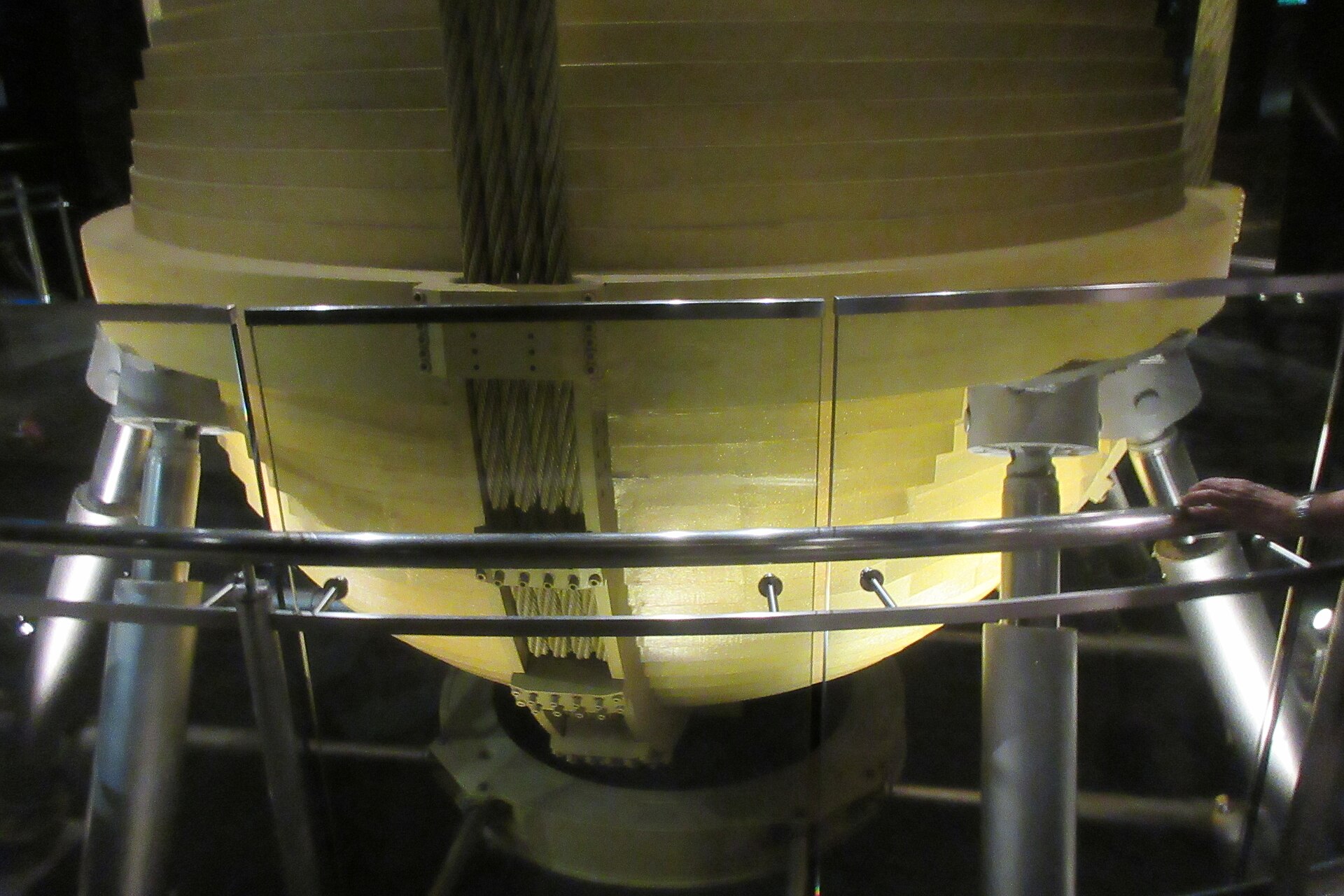 The tuned mass damper, a large golden steel sphere suspended on cables, on display inside the Taipei 101 observatory