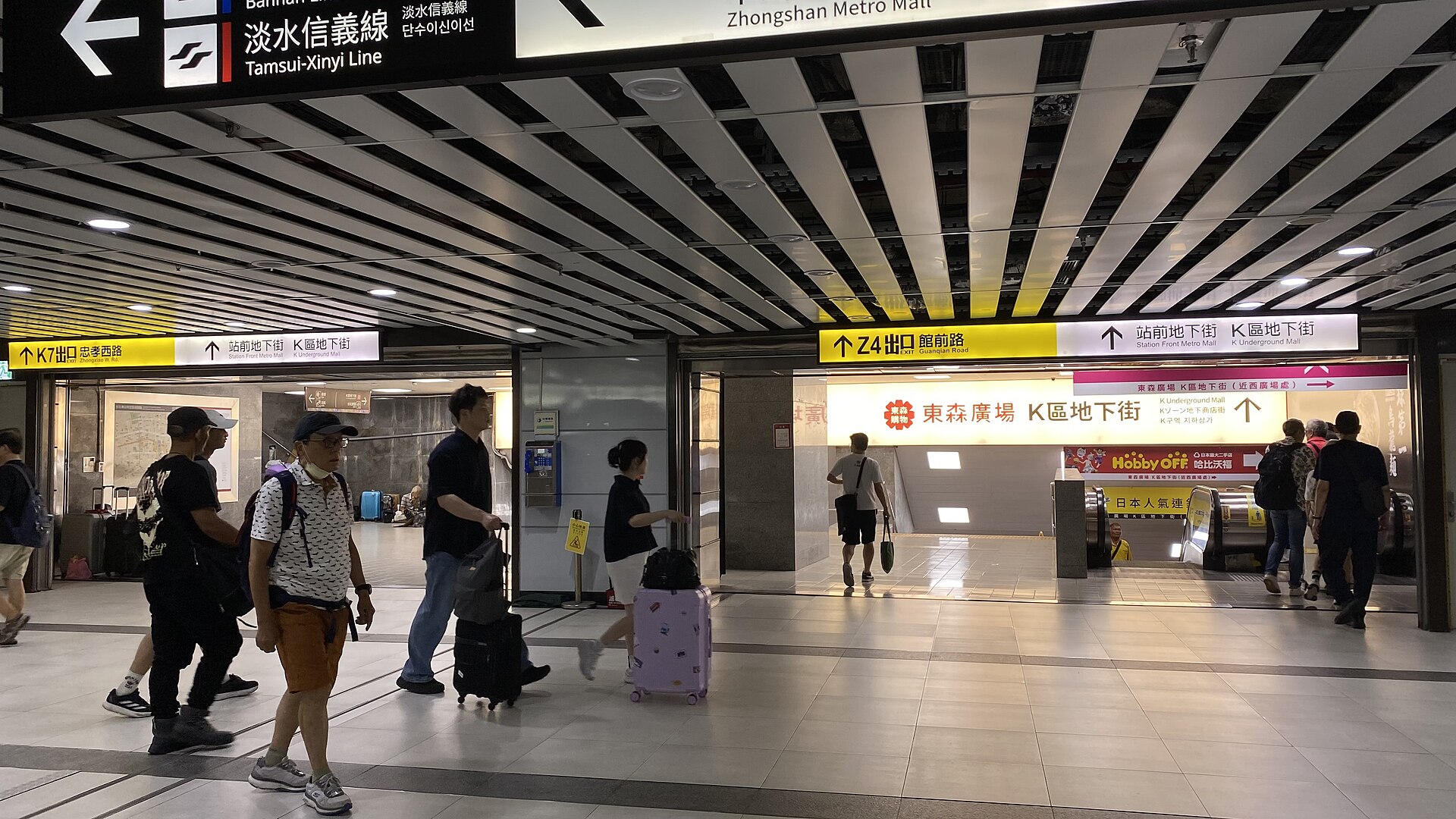 Passengers with luggage in the B1 underground concourse at Taipei Main Station